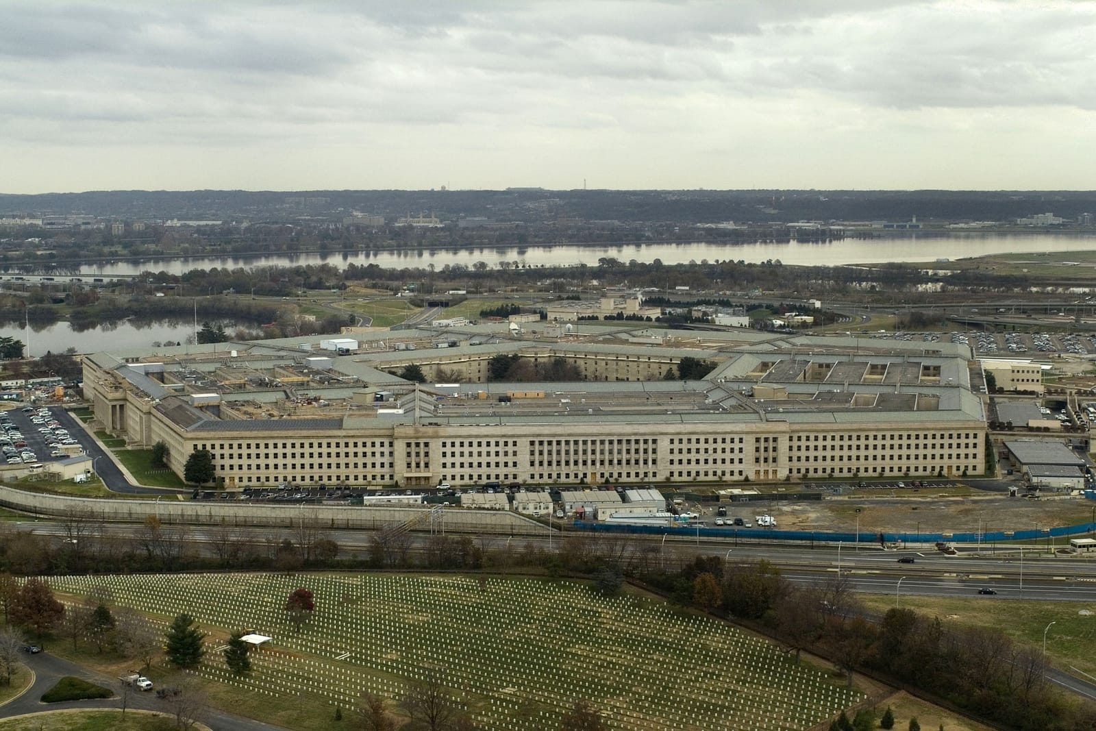 Aerial view of the Pentagon between the Potomac River and Arlington National Cemetery (section 69 visible at bottom), 2005