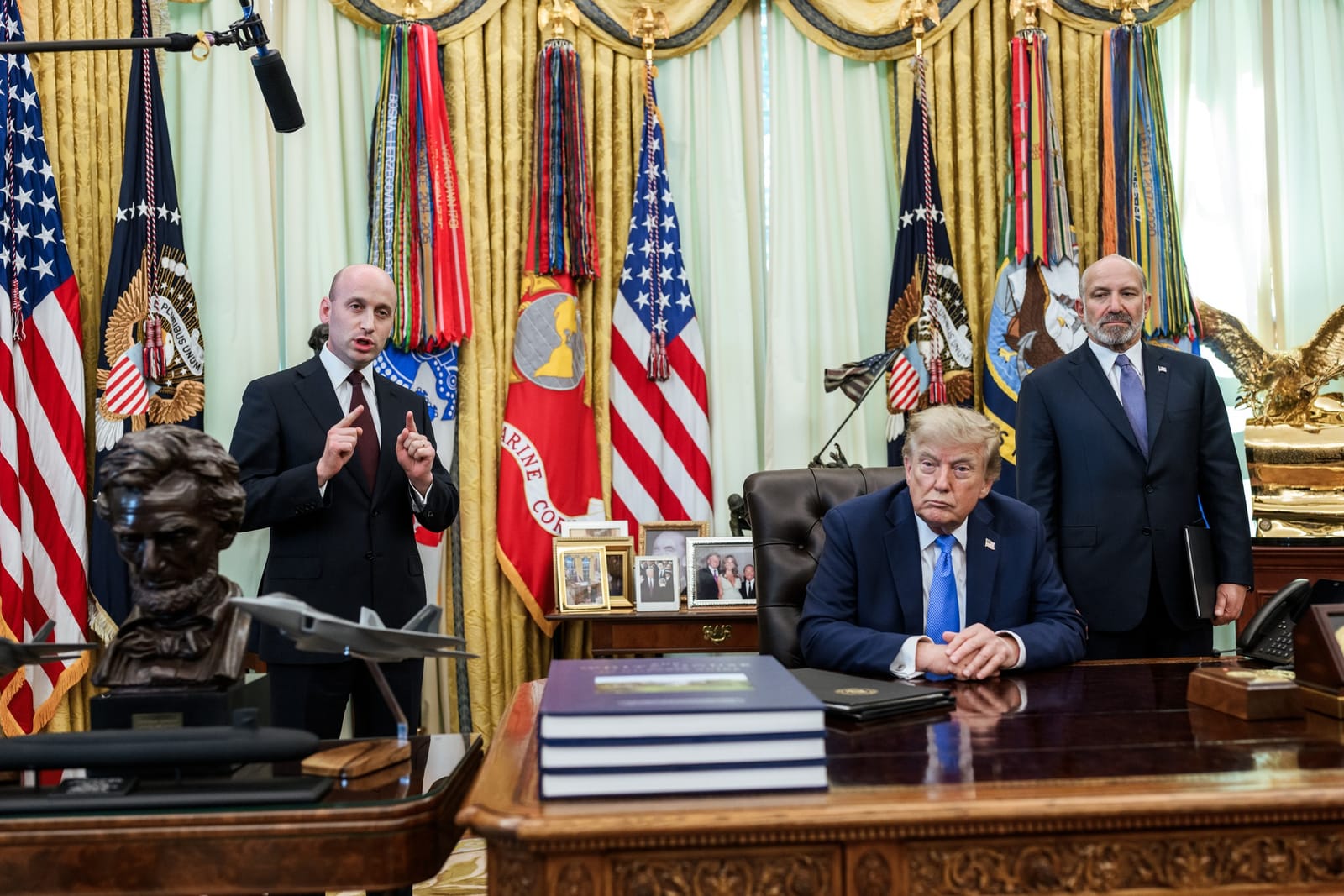 Trump signing executive orders in the Oval Office with Deputy Chief of Staff Stephen Miller and Commerce Secretary Howard Lutnick, Thursday, Aug. 6, 2026
