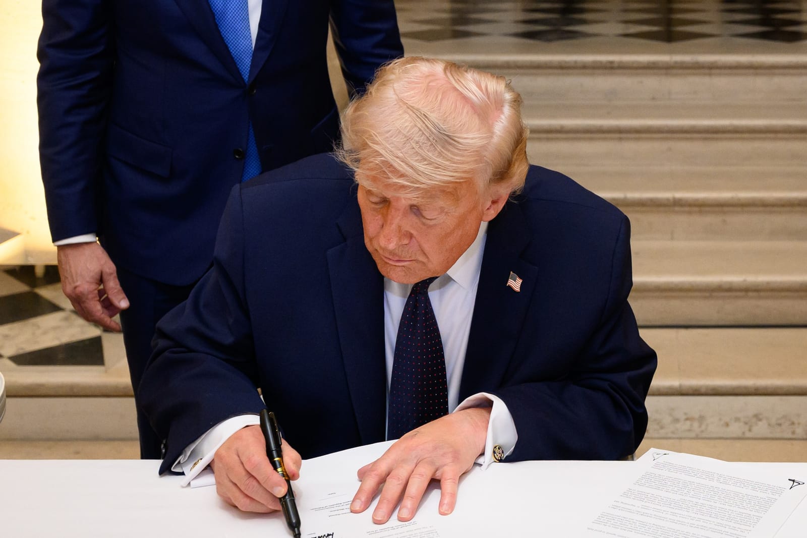 President Trump signing the Iran-US Islamabad Memorandum of Understanding at the Palace of Versailles, June 17, 2026; the Macrons attending.