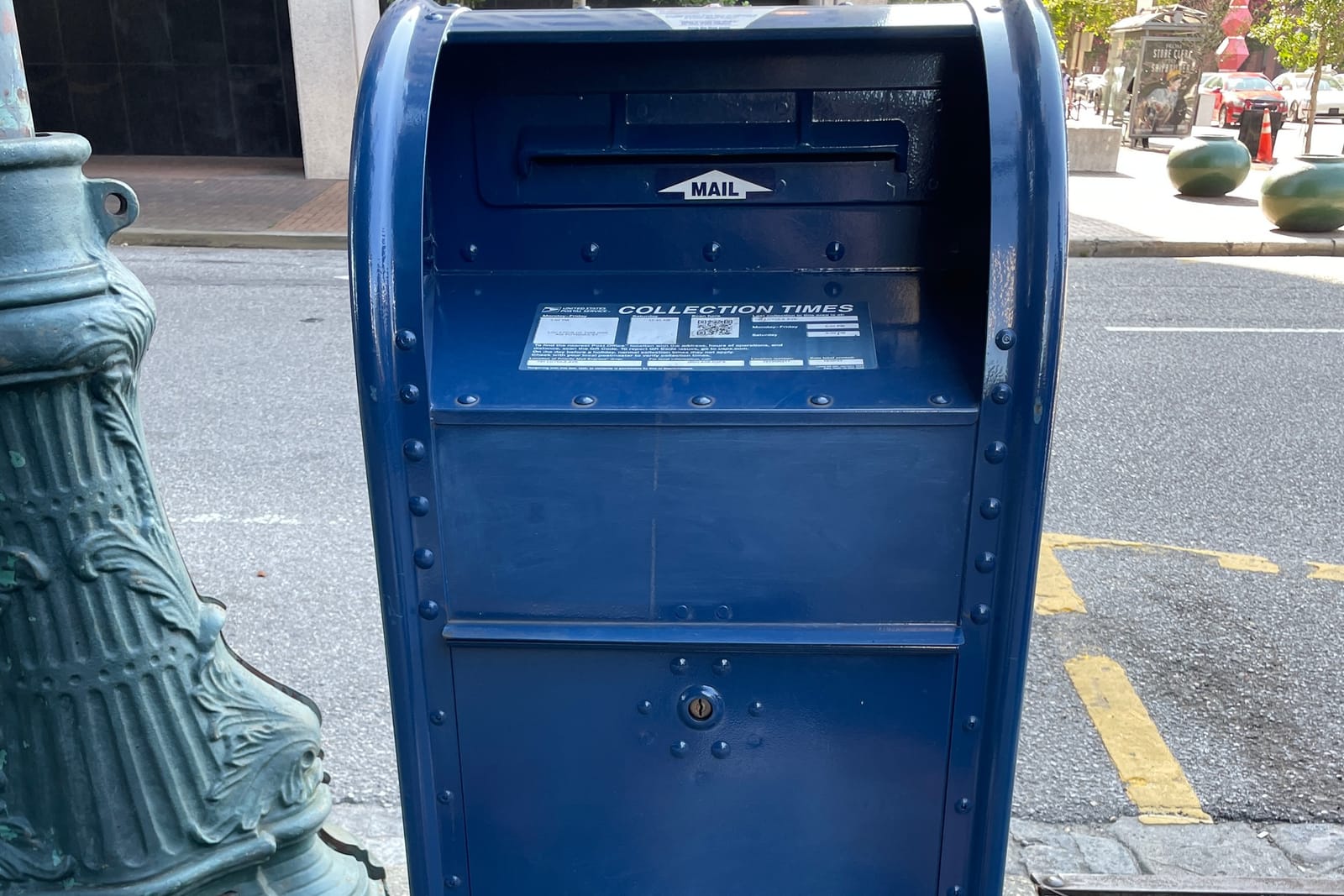 A blue USPS collection box at Magazine and Poydras, New Orleans, June 2026